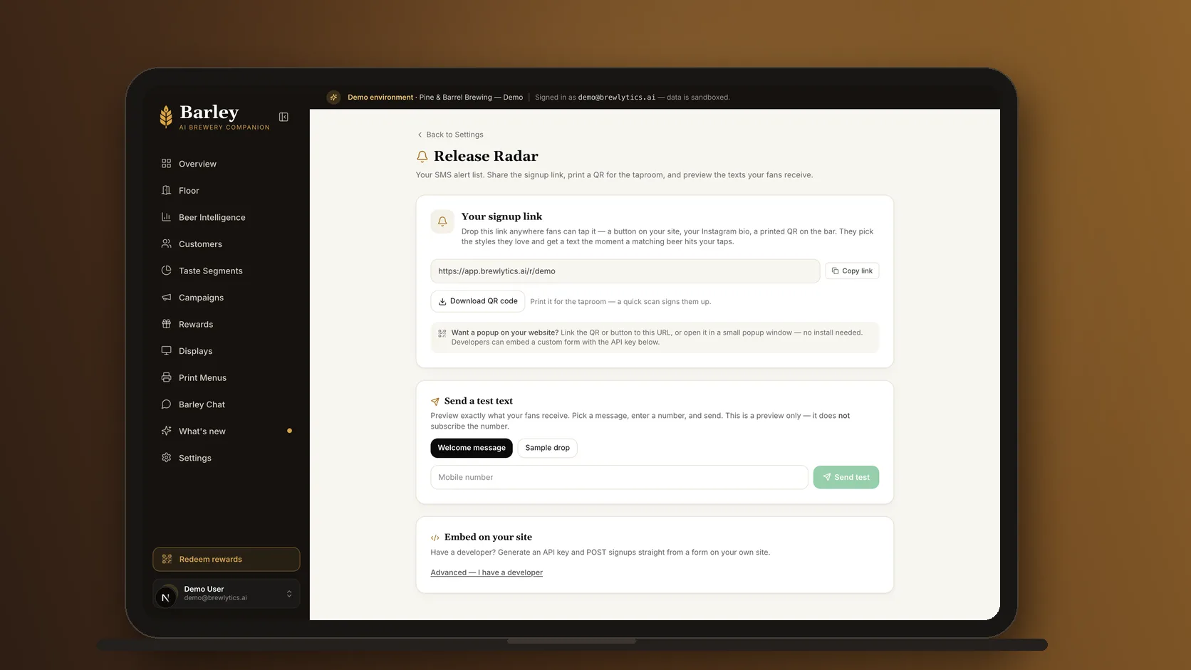 The Brewlytics Release Radar settings on a laptop: the brewery's signup link, the QR code to download for table tents, a test-text box, and the embed for the website.