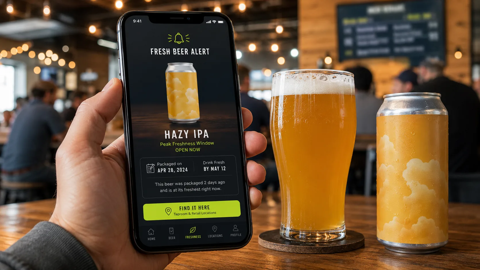 A phone showing a Brewlytics "Fresh Beer Alert" for a Hazy IPA — "Peak Freshness Window: Open Now, Packaged on Apr 28, Drink Fresh by May 12, packaged 2 days ago and at its freshest right now" — next to a full hazy pour and a matching can on a taproom table.